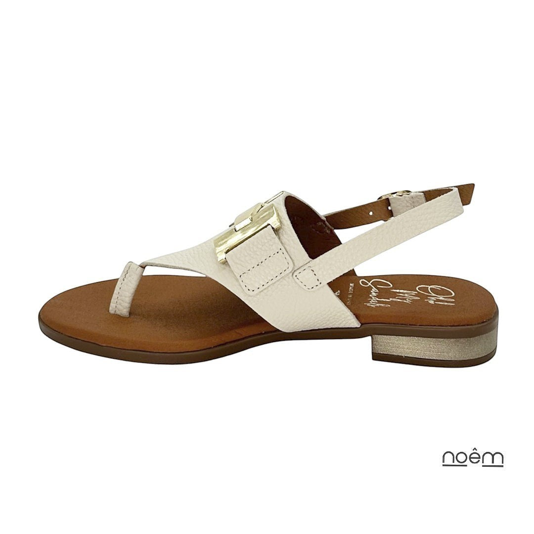 Sandalia beige de piel con detalle metálico dorado y tira al tobillo. Calzado elegante y cómodo.